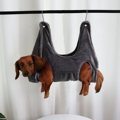 Pink PawCare™ grooming hammock for pets, providing stress-free support during nail care and grooming sessions.